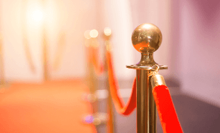 A red rope is wrapped around the top of a gold pole.